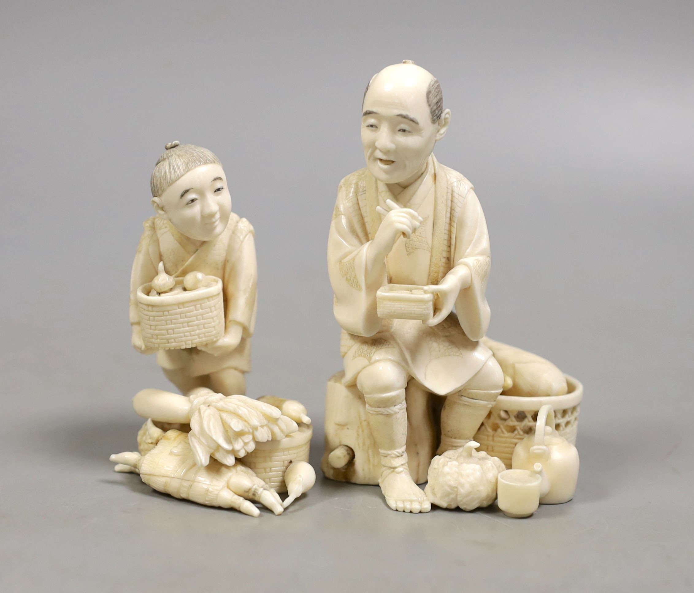 A Japanese ivory group of a farmer and boy, early 20th century, farmer 11.5 cms high.